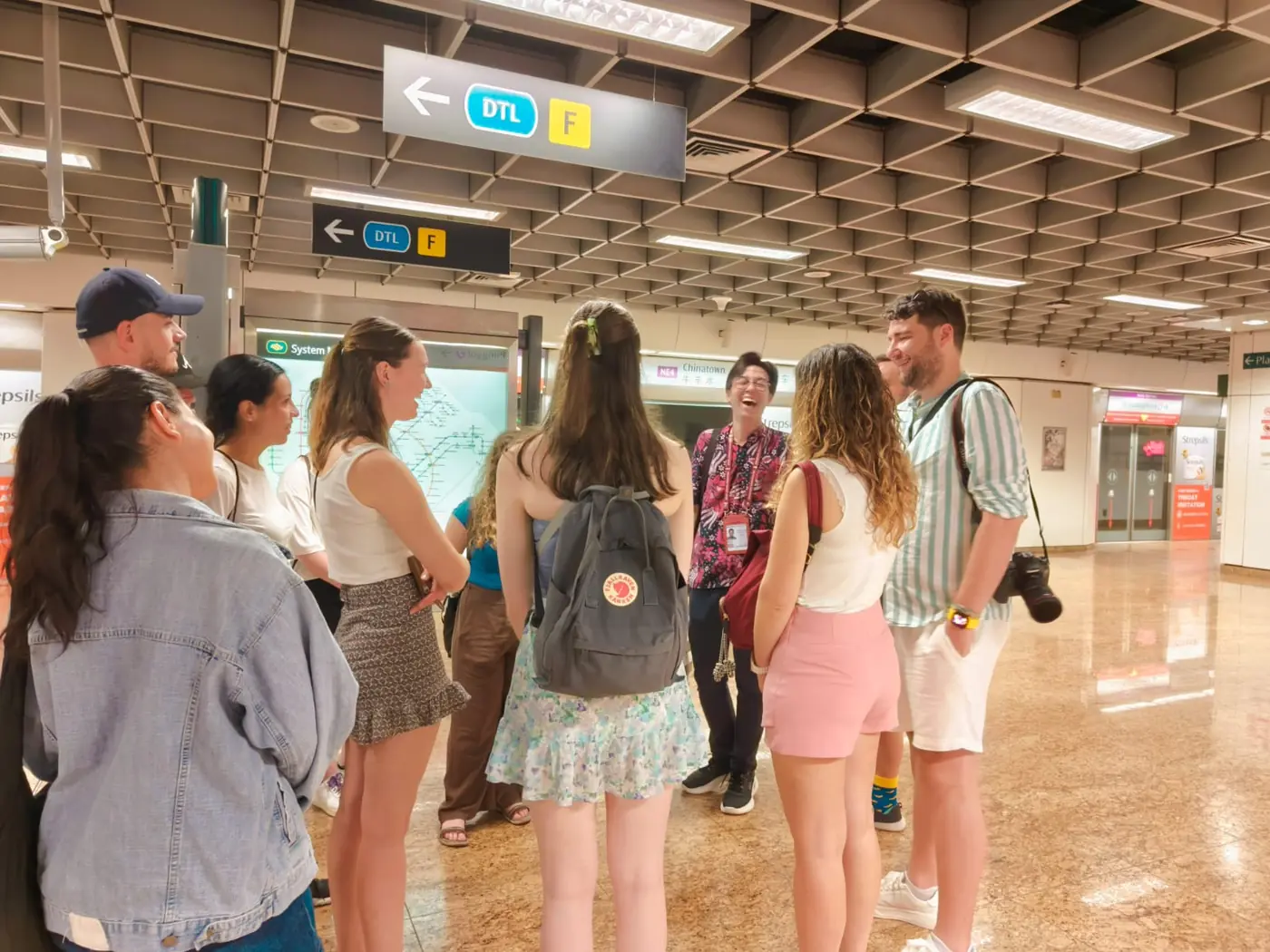 Adam guiding a group of visitors at Chinatown MRT station in Singapore