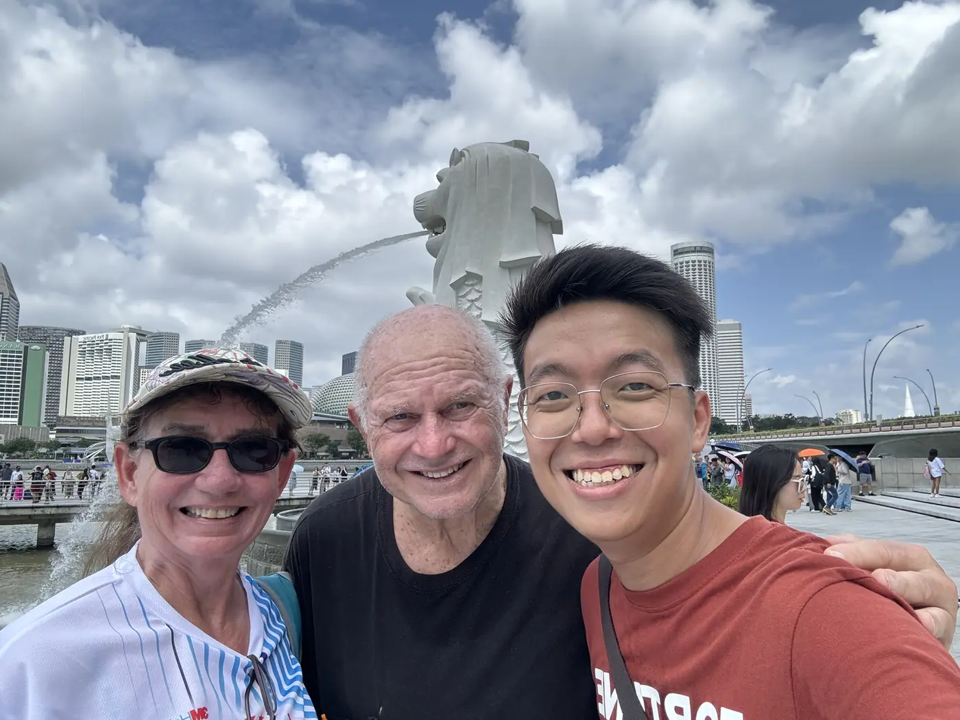 Adam with guests on a private Singapore tour near the Merlion