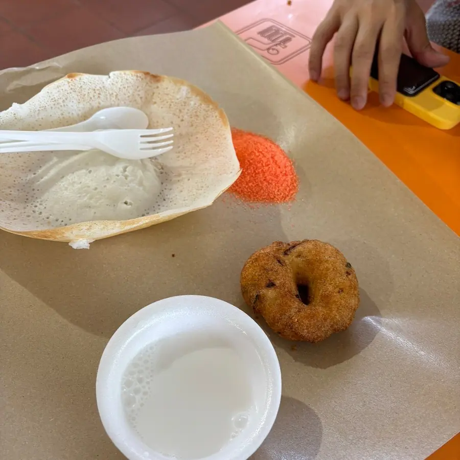 Appam, vadai and a drink served during a Singapore food tasting