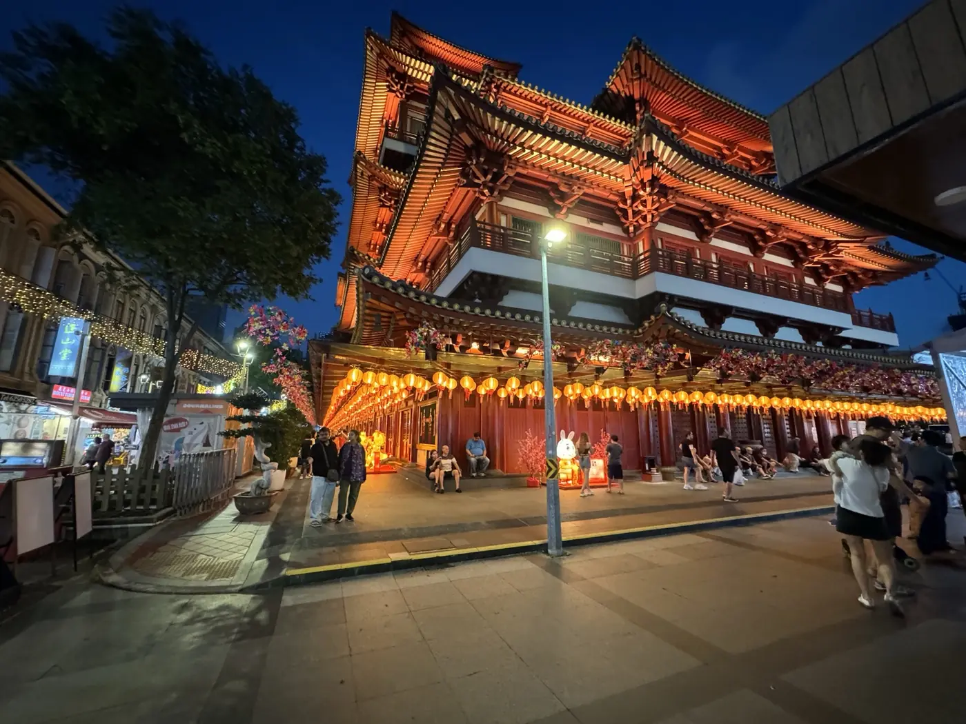 Buddha Tooth Relic Temple illuminated at dusk in Chinatown, Singapore